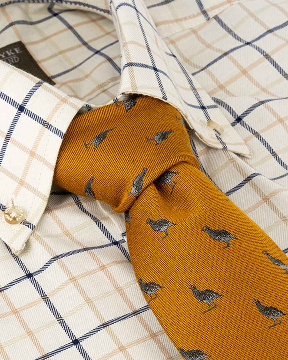 Mustard coloured Jack Pyke Silk Tie Partridge on shirt background