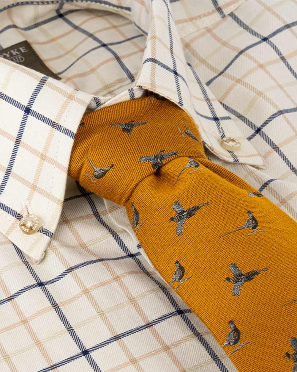 Mustard coloured Jack Pyke Silk Tie Pheasant on shirt background