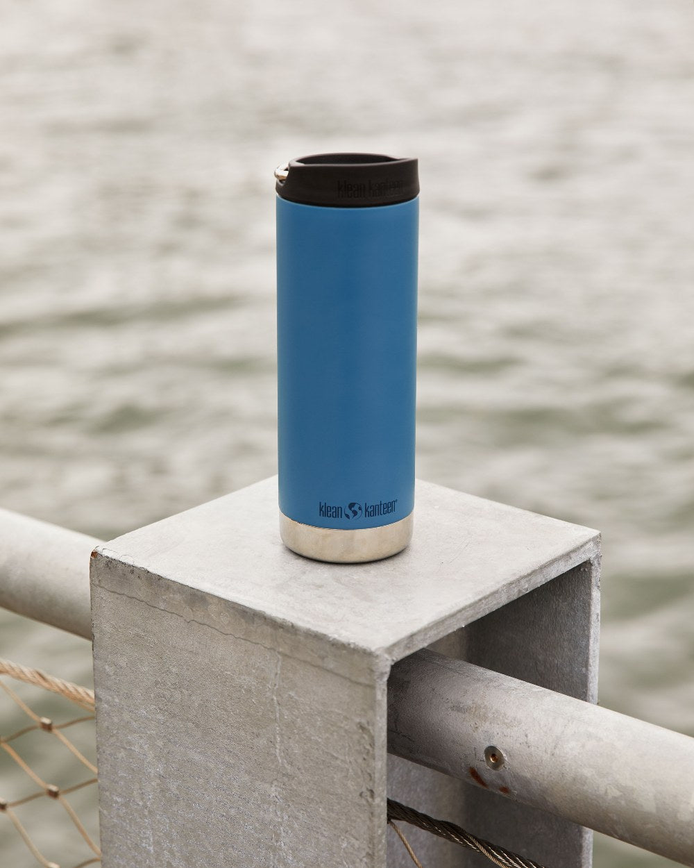 Real Teal Coloured Klean Kanteen Insulated TKWide With Cafe Cap On A River Background