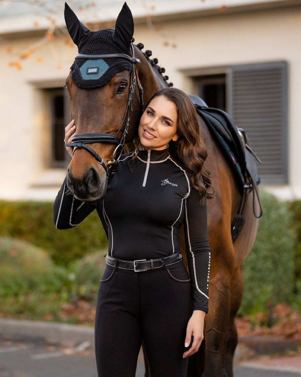 Black coloured LeMieux Base Layer with horse in background