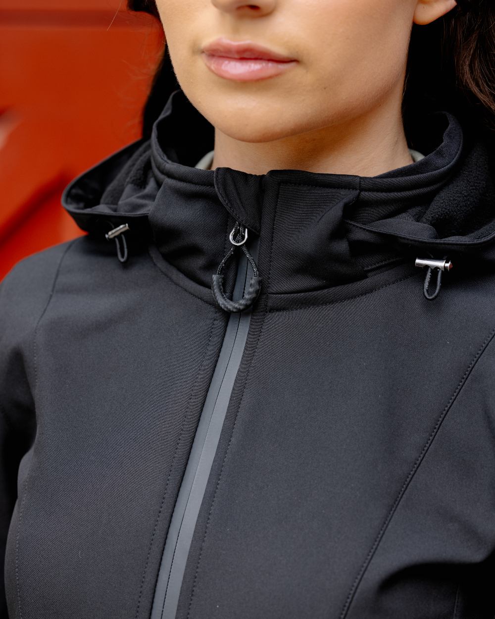 Black coloured LeMieux Celine Softshell Jacket on red background