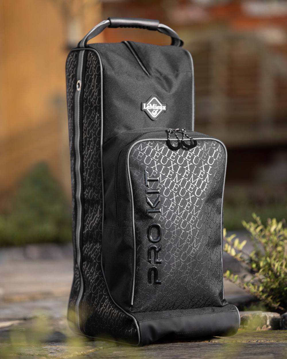 Black coloured LeMieux Elite Pro Boot &amp; Hat Bag on blurry background 