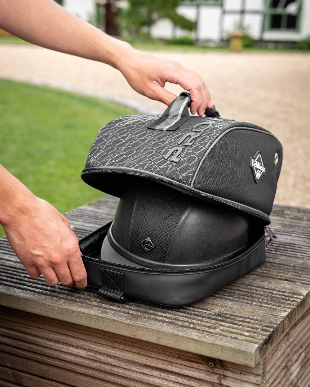 Black coloured LeMieux Elite Pro Hat Box on wooden background