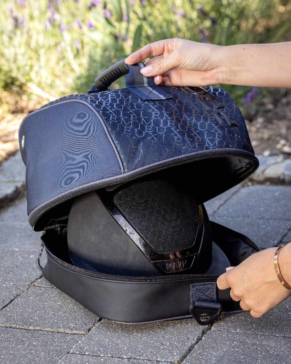 Navy coloured LeMieux Elite Pro Hat Box on paved background
