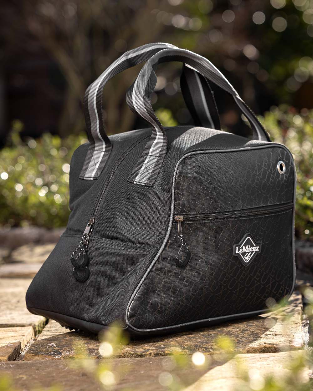 Black coloured LeMieux Elite Pro Short Boot Bag on green background