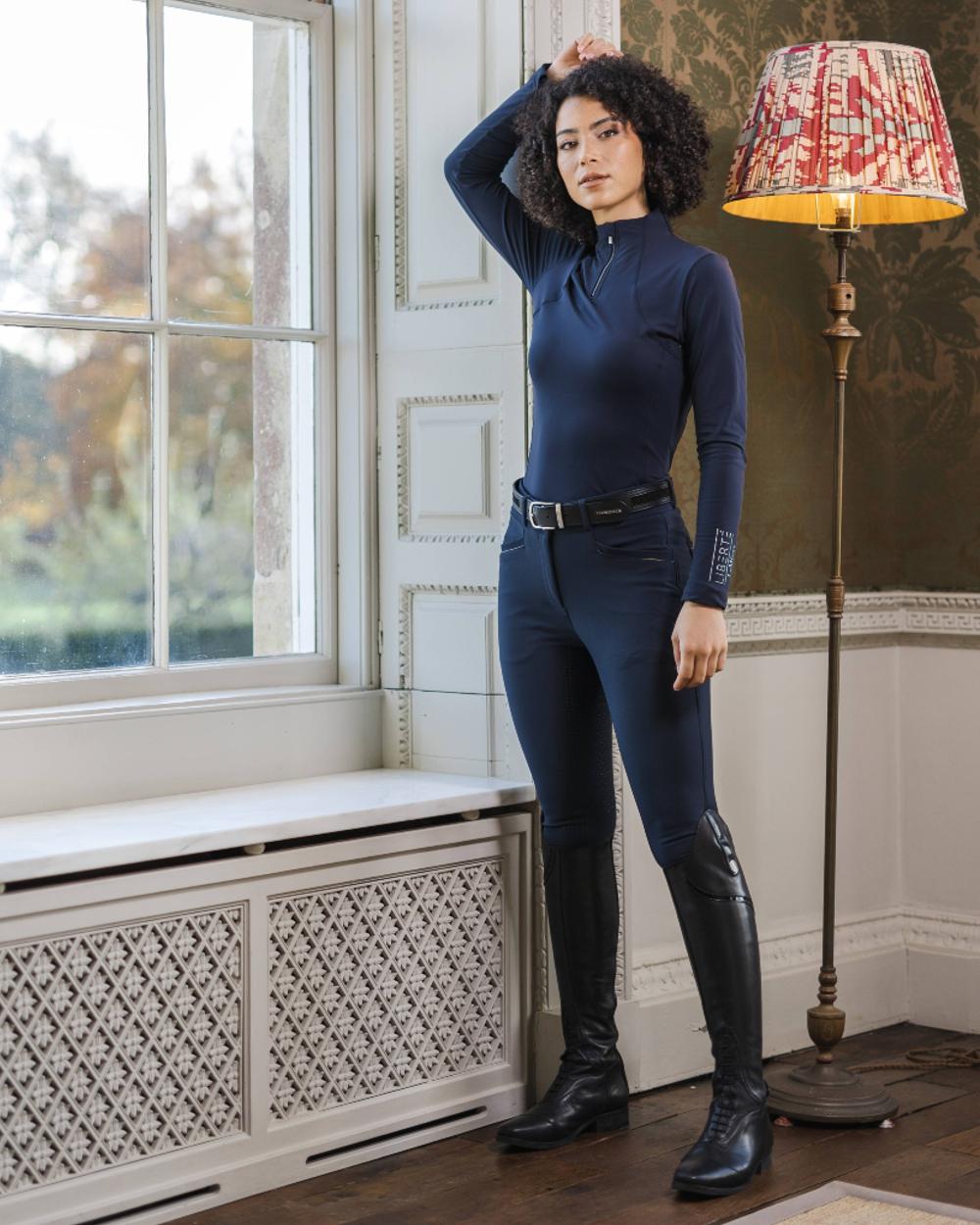 Navy coloured LeMieux Freya Pro Breeches with window in background 