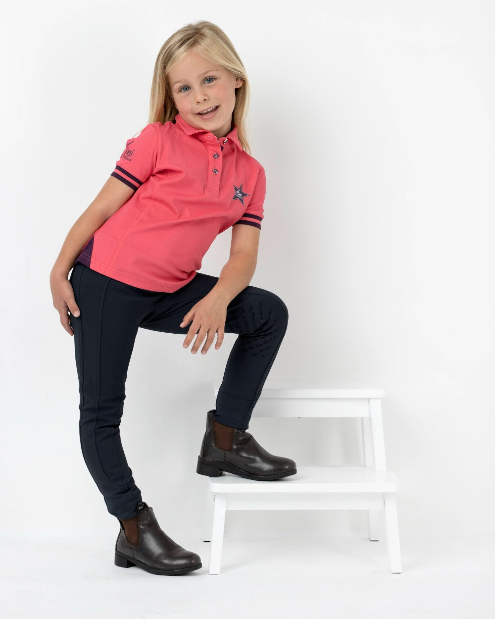 Black coloured LeMieux Junior Pro Breeches on grey background