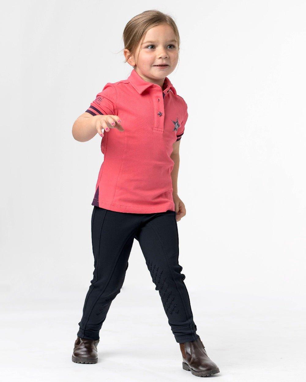Black coloured LeMieux Junior Pro Breeches on grey background