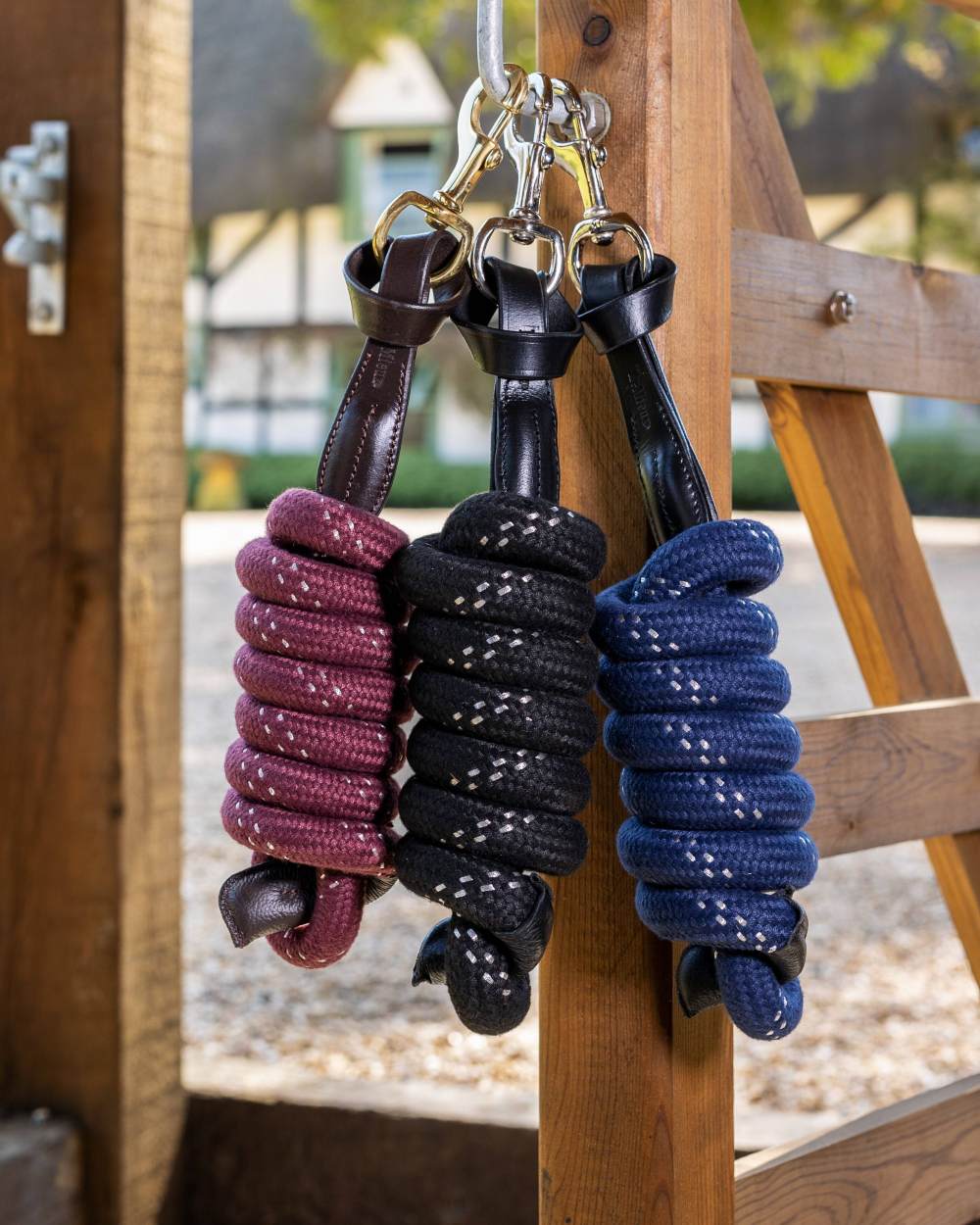 Burgundy coloured LeMieux Lasso Lead Rope on wooden background