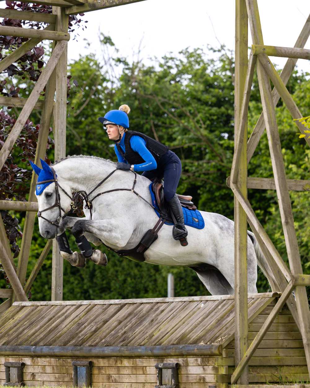 Benetton Coloured LeMieux Loire Close Contact Square On A Riding Arena Background