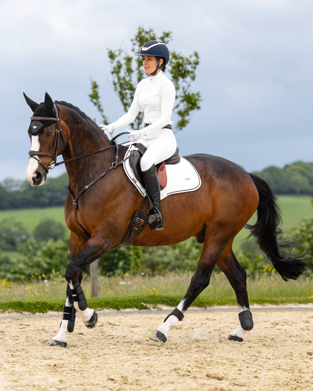 White Coloured LeMieux Loire Close Contact Square On A Riding Arena Background