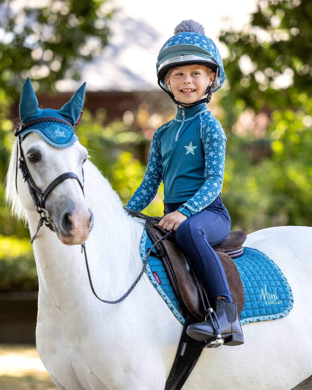 Marine coloured LeMieux Mini Base Layers on blurry green background