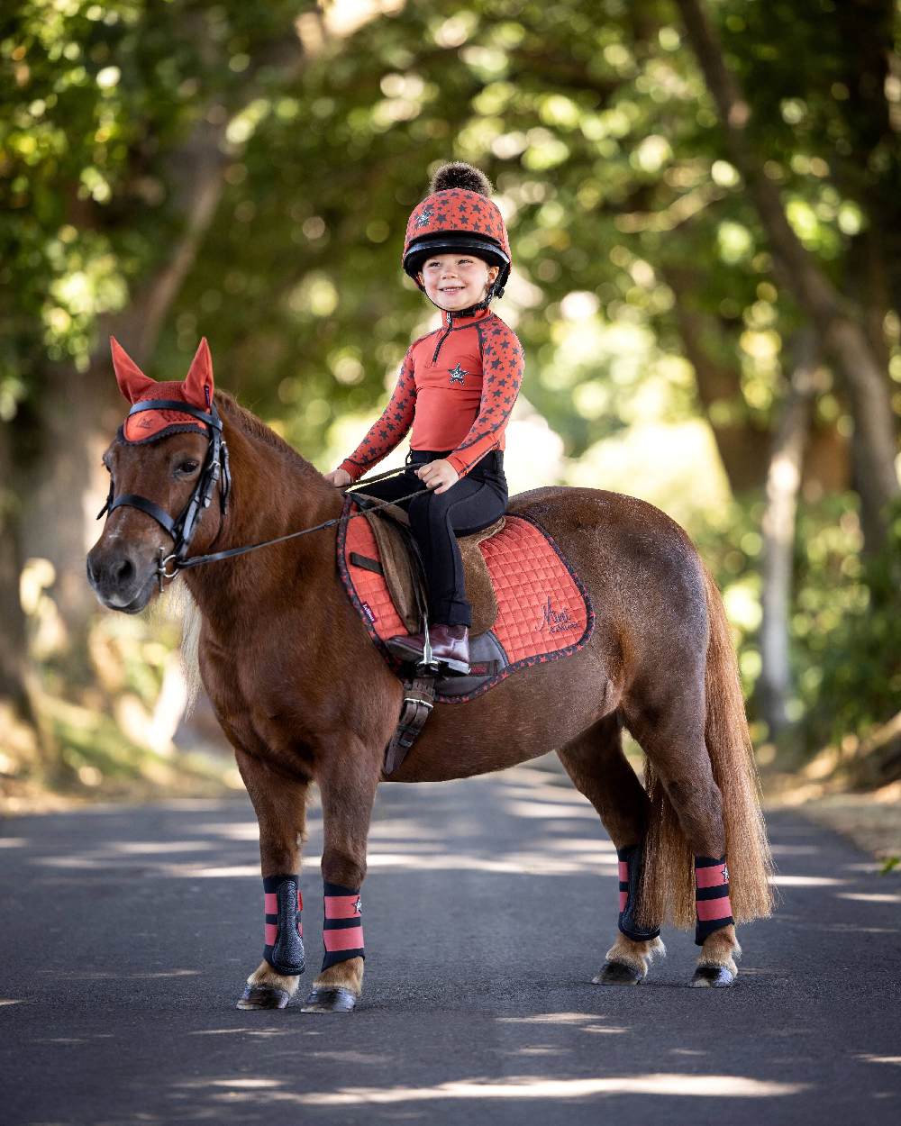 Sienna coloured LeMieux Mini Base Layers on blurry green background