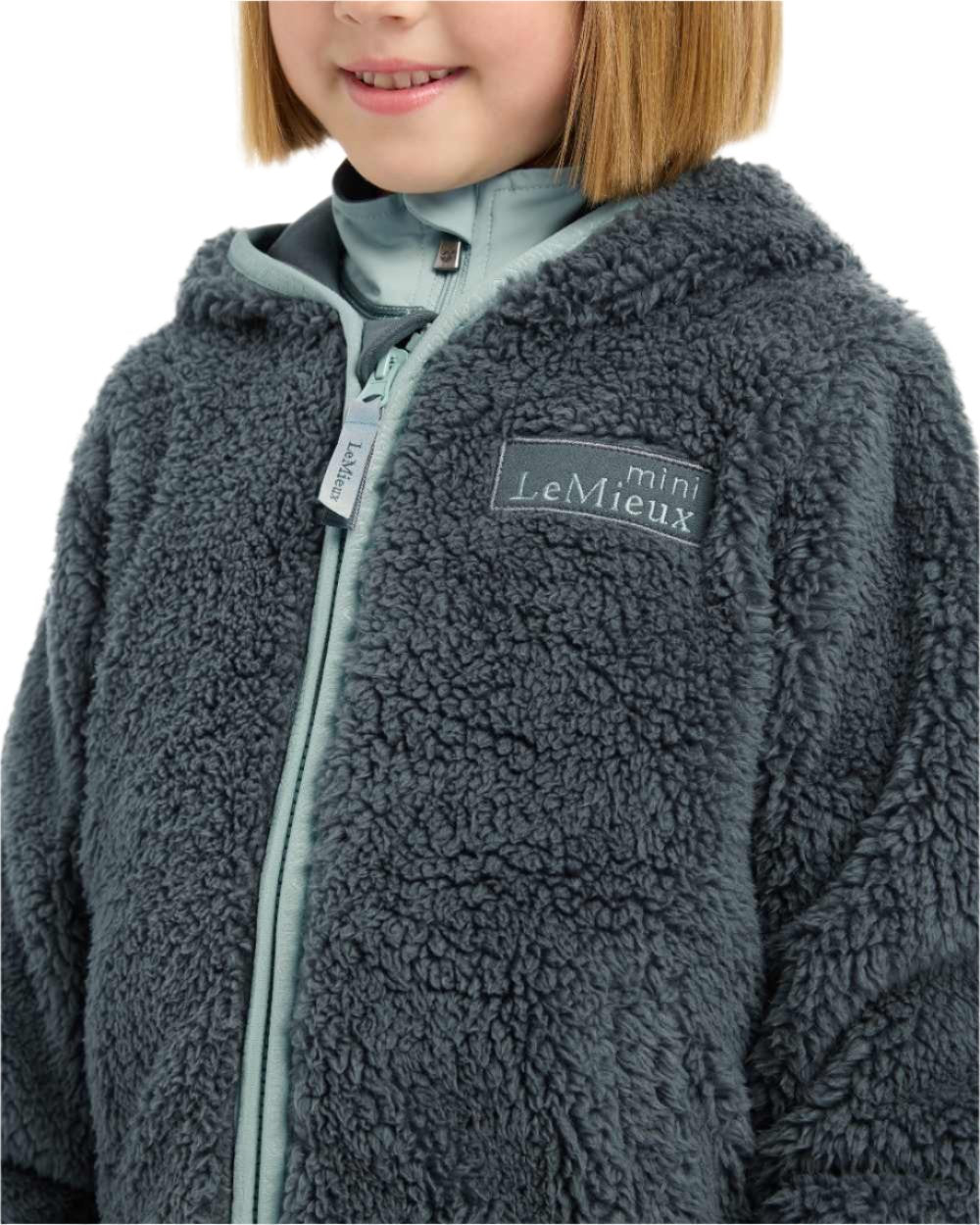 Petrol Coloured LeMieux Mini Teagan Fleece Jacket On A White Background