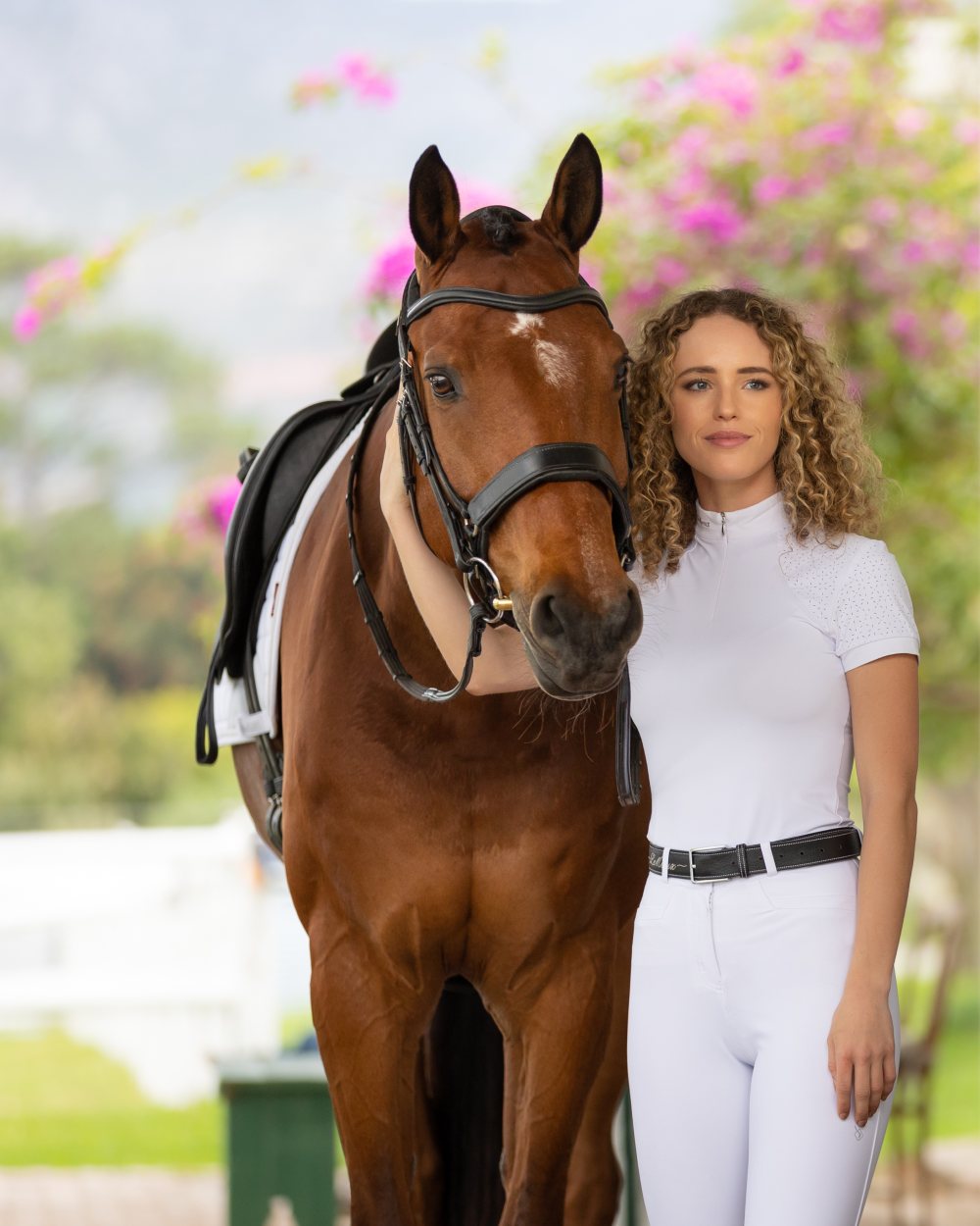 White coloured LeMieux Olivia Short Sleeve Show Shirts with horse in background 