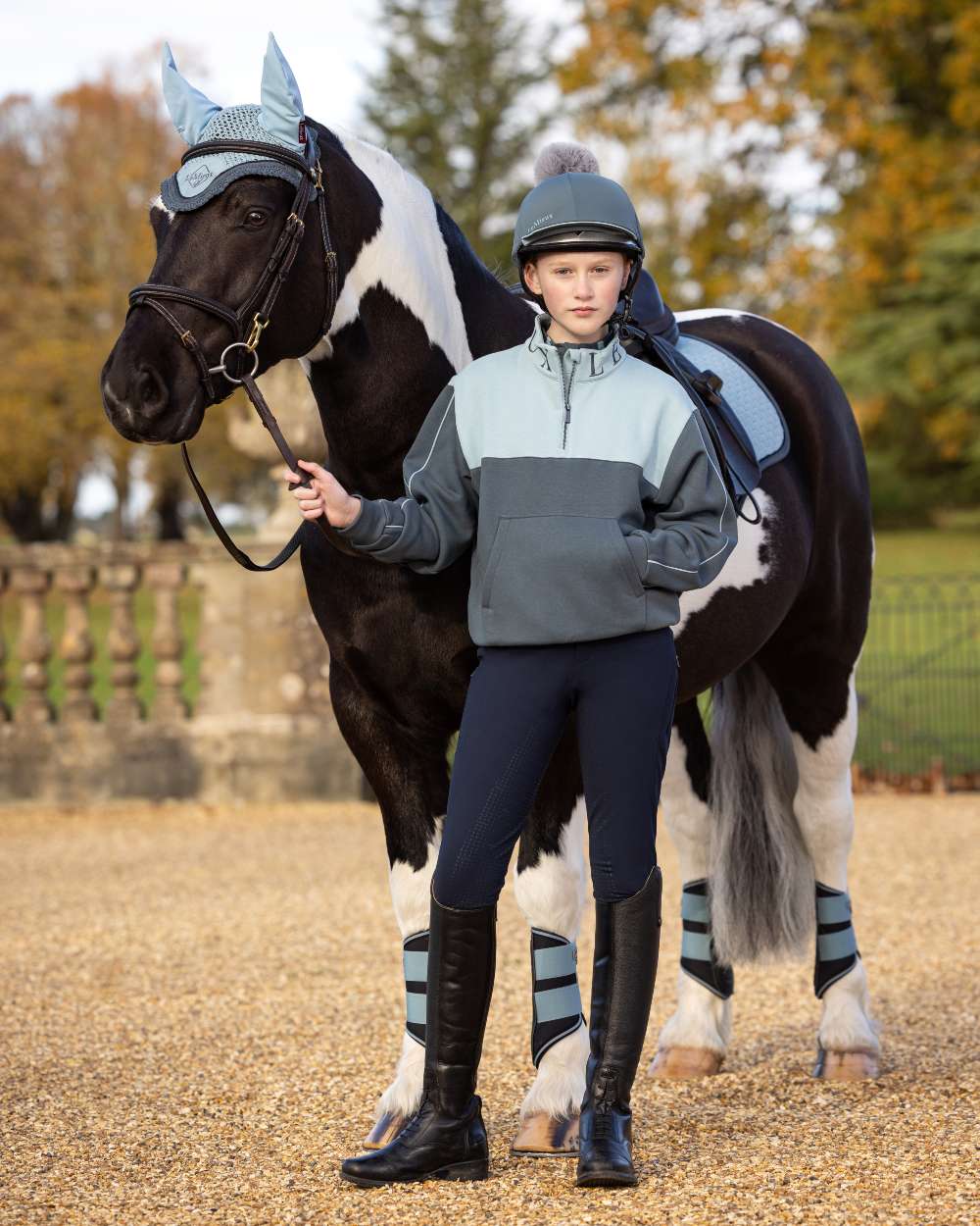 Petrol Coloured LeMieux Pippa Hat Silk On A Outer Yard Background