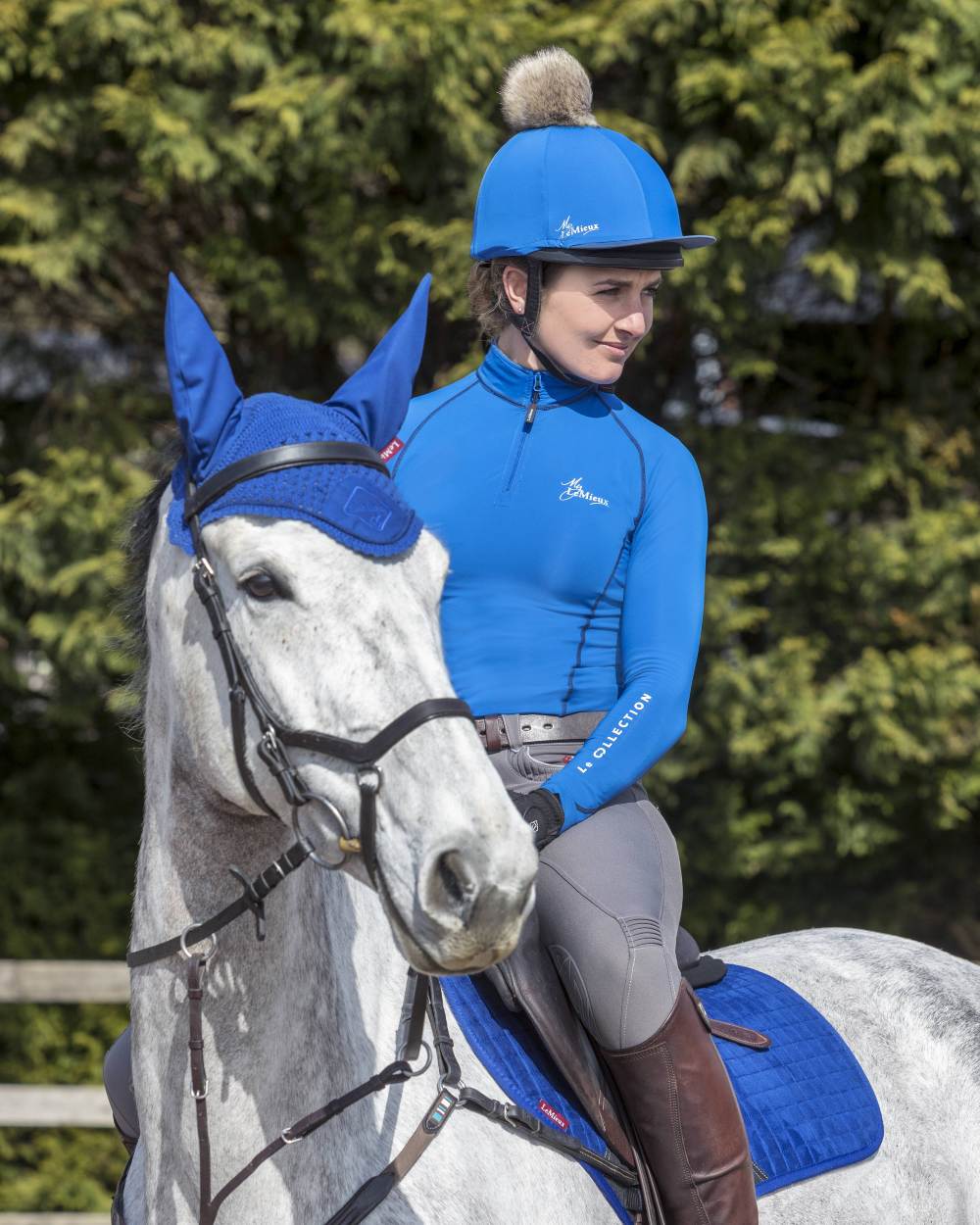 Benetton Blue Coloured LeMieux Pom Hat Silk On Blurry Trees Background
