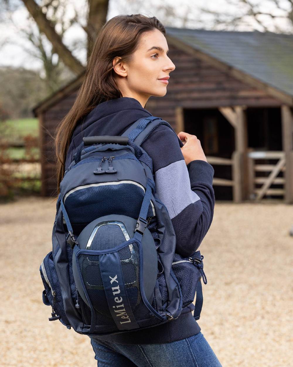Navy coloured LeMieux Pro Rucksack on blurry stable background