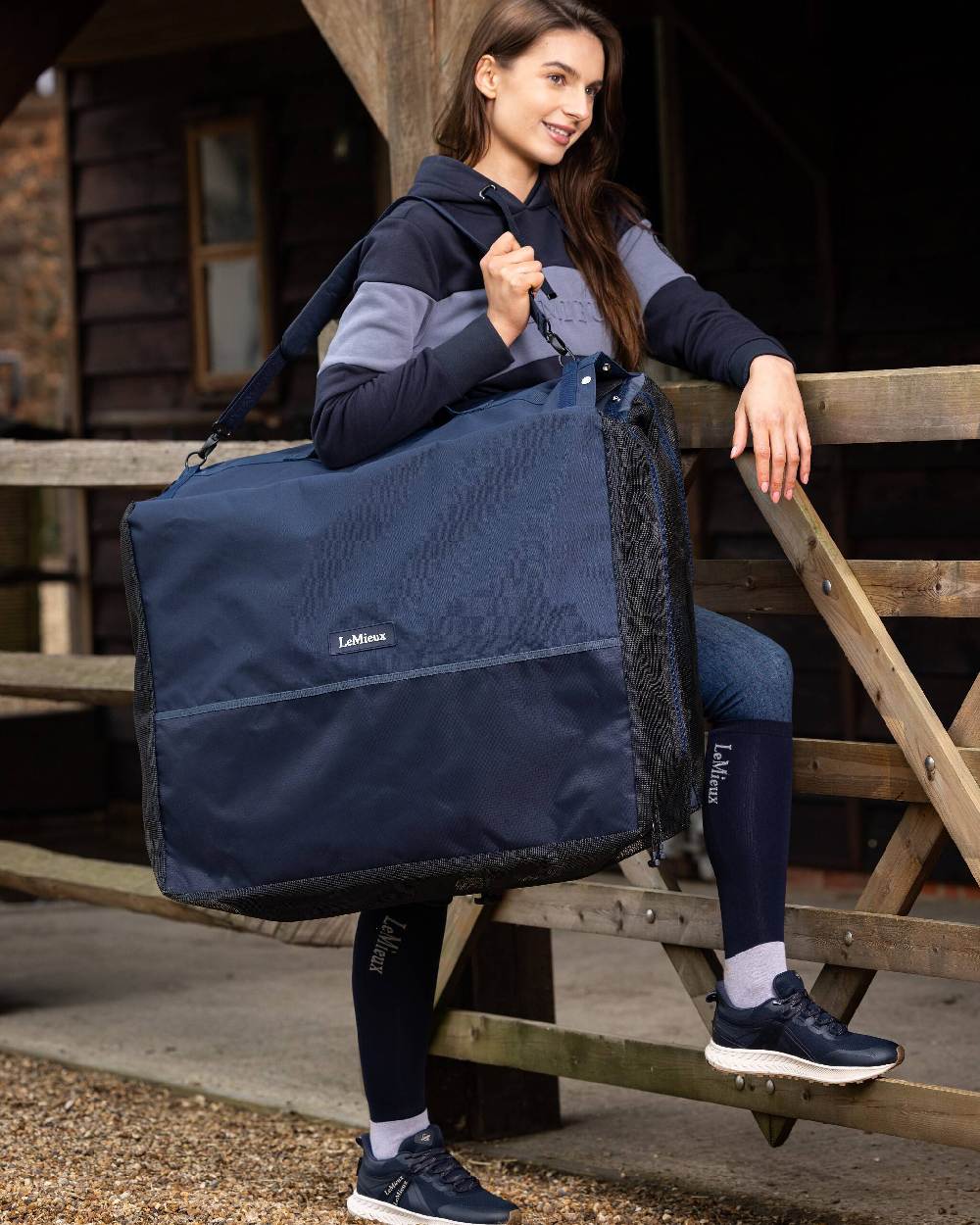 Navy coloured LeMieux Saddle Pad Carry Bag on stable background