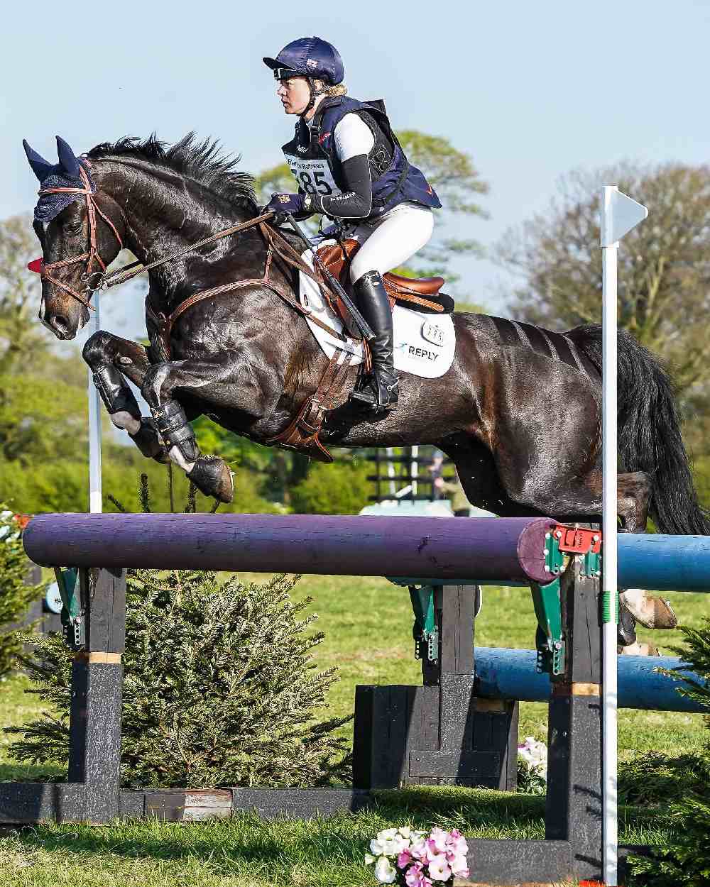 White coloured LeMieux Suede Close Contact Squares on show jumping background