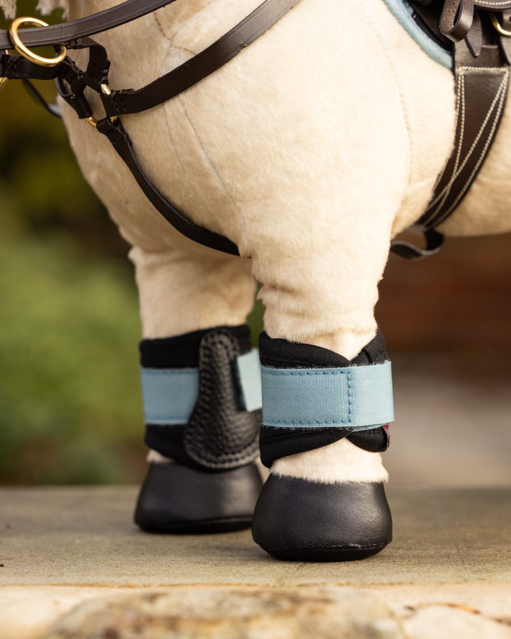 Glacier Coloured LeMieux Toy Pony Grafter Boots On A Outer Yard Background