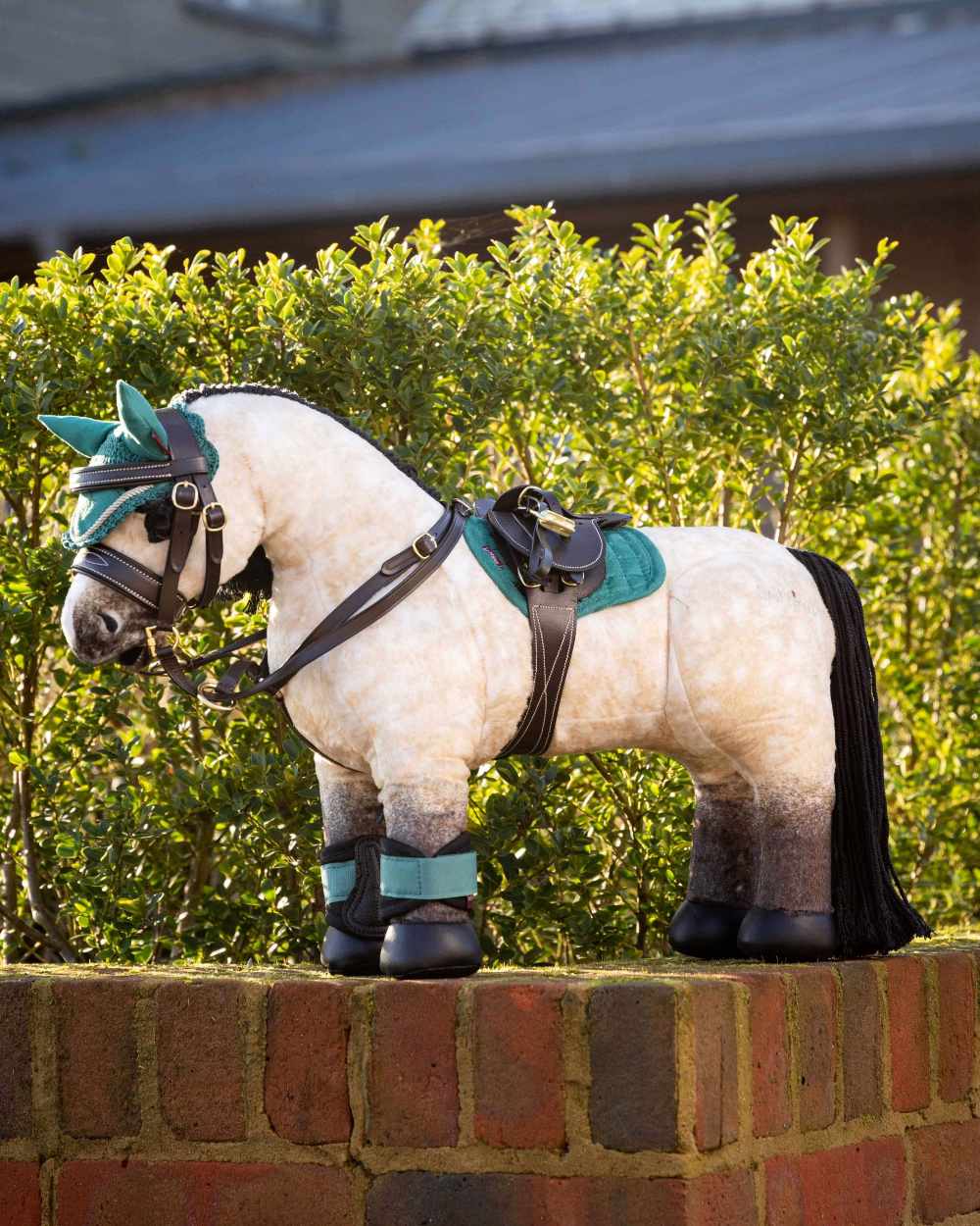 Brown coloured LeMieux Toy Pony Martingale on green background