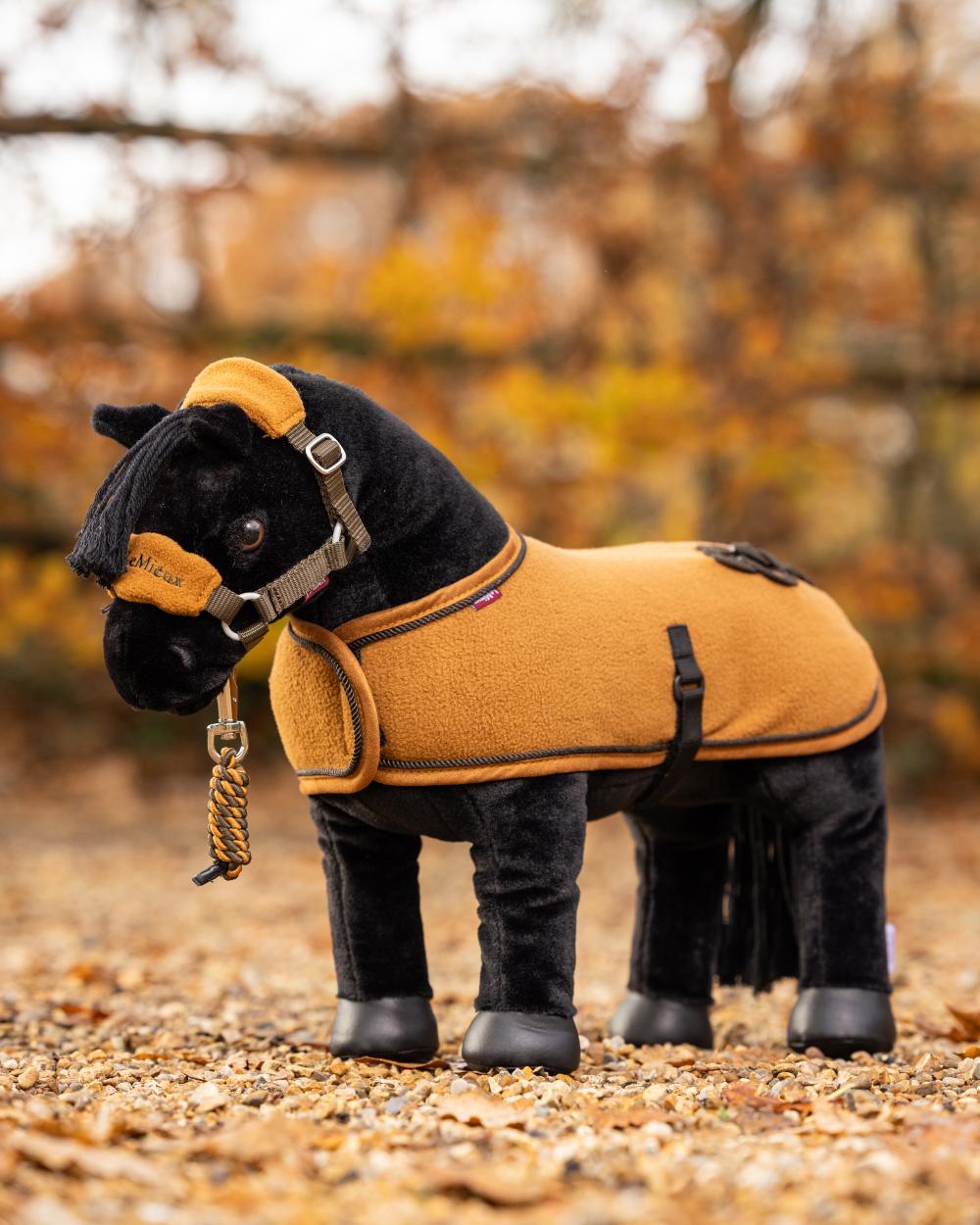 Ginger Coloured LeMieux Toy Pony Rug On A Stable Background