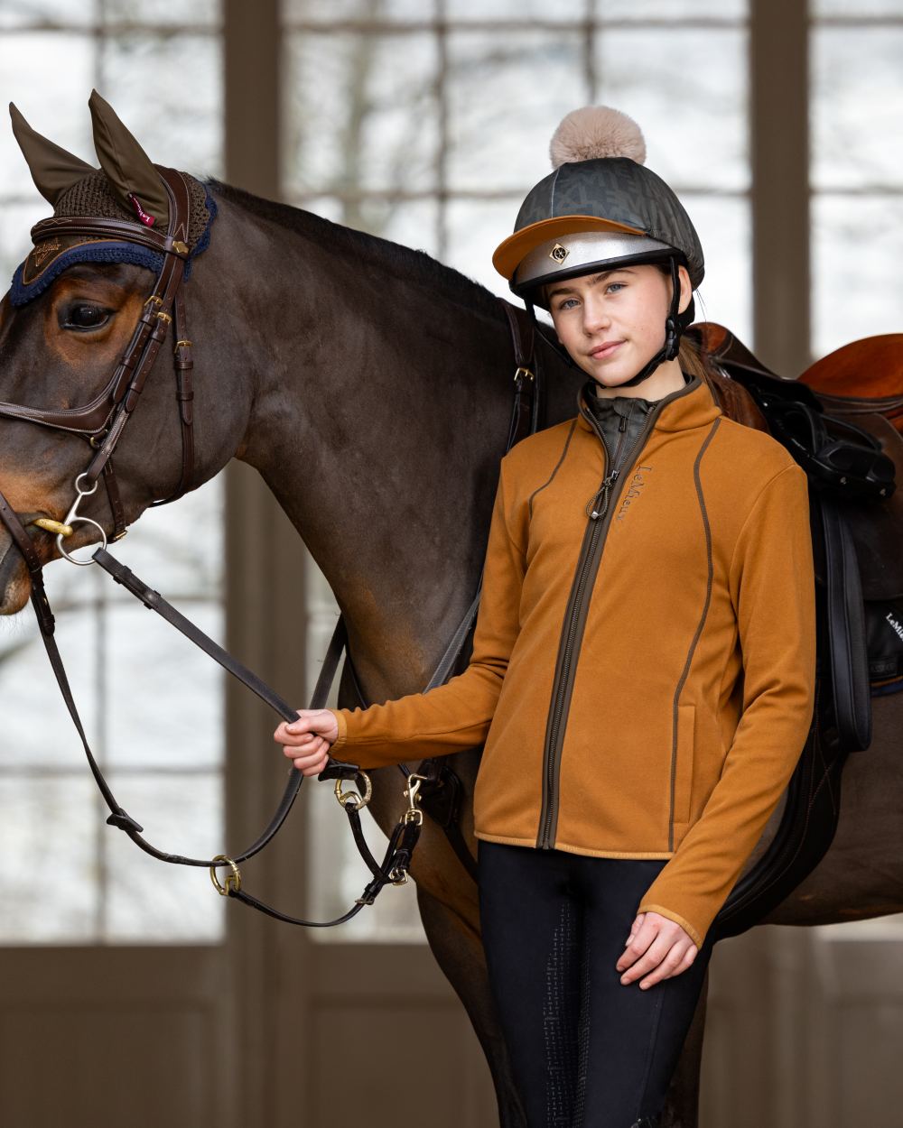 Ginger Coloured LeMieux Young Rider Felicity Fleece Zip Through Jacket On A Stable Background