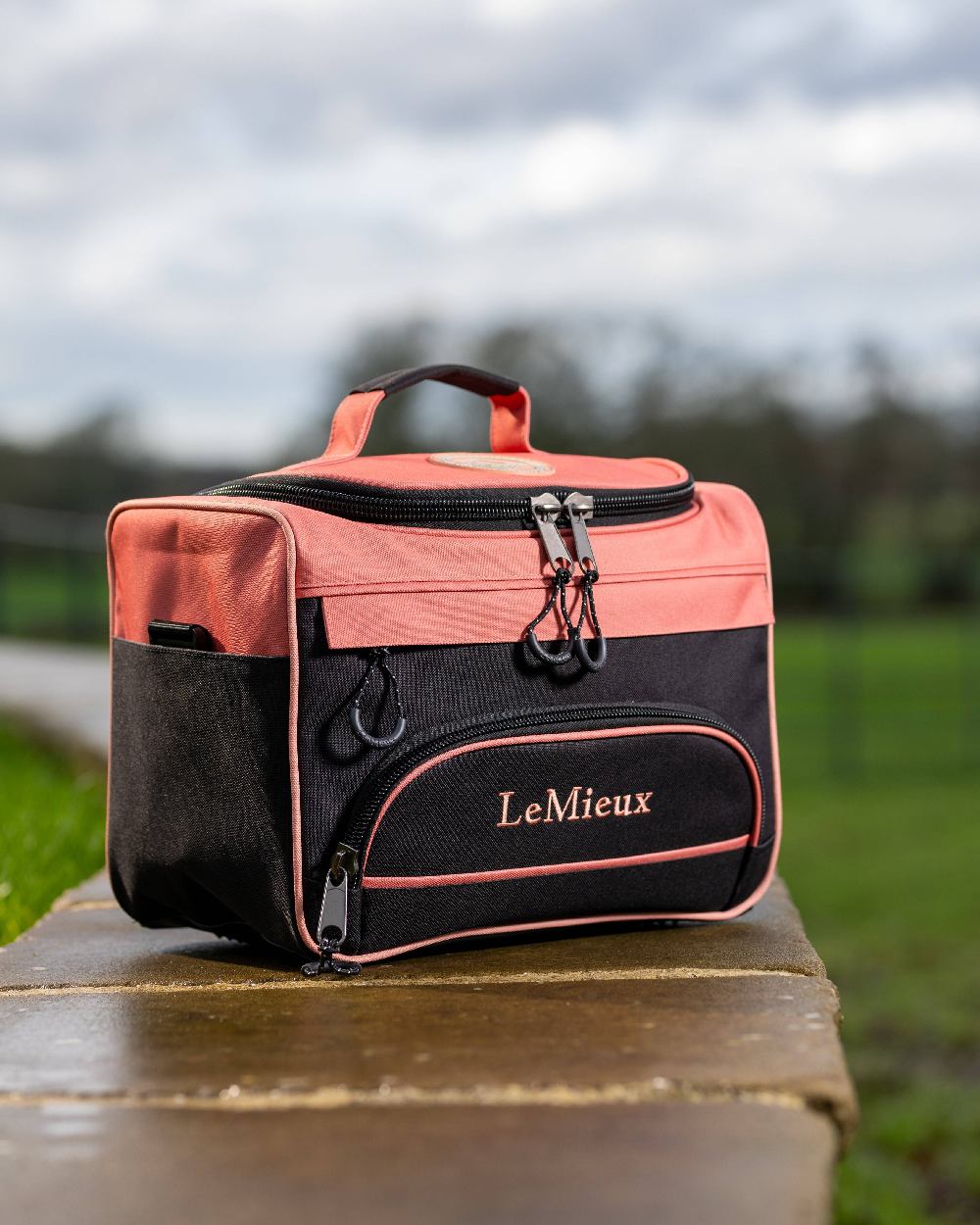Apricot coloured LeMieux ProKit Lite Grooming Bag on blurry background 