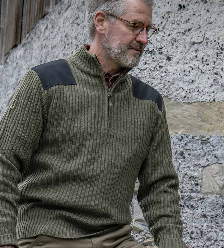 Man wears Deerhunter ribbed knit zip neck pullover in green wool with shooting shoulder patches | Men's Country Knitwear