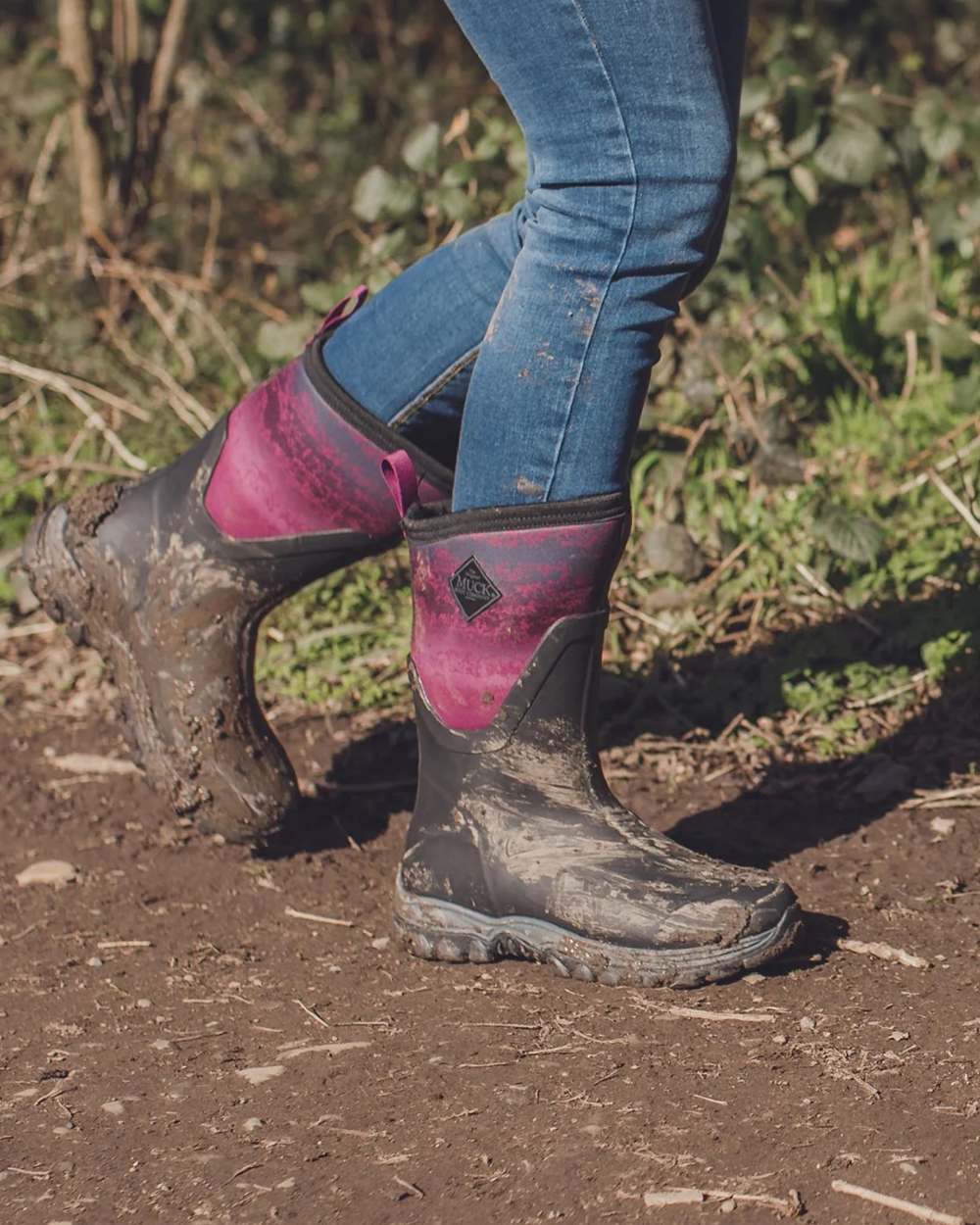Magenta Digi Fade Print Coloured Muck Boots Womens Arctic Sport II Mid Wellingtons On A Field Background