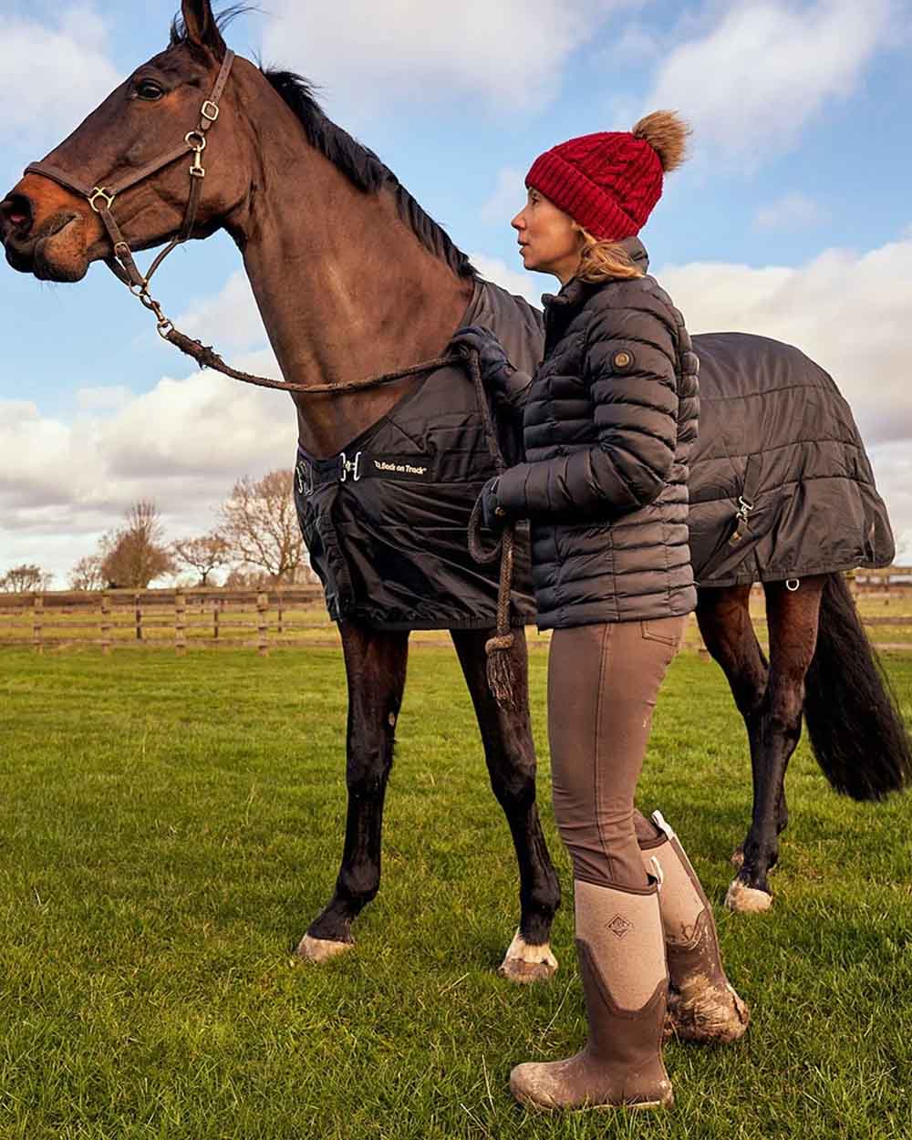 Chocolate Brown Walnut Woven Muck Boots Womens Artic Sport II Tall Wellingtons on Horse Pen background