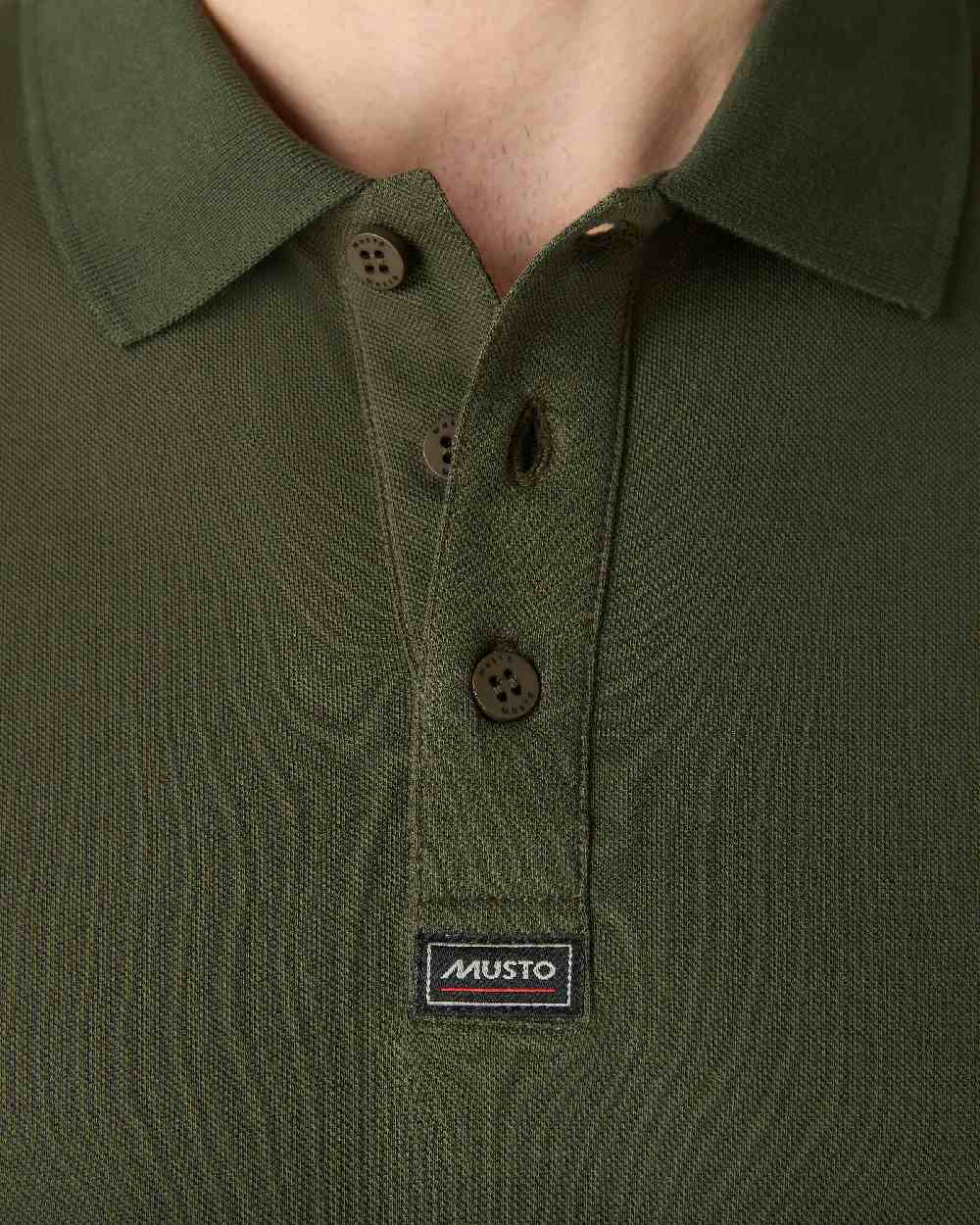 Deep Green coloured Musto Essential Pique Polo Shirt on White background