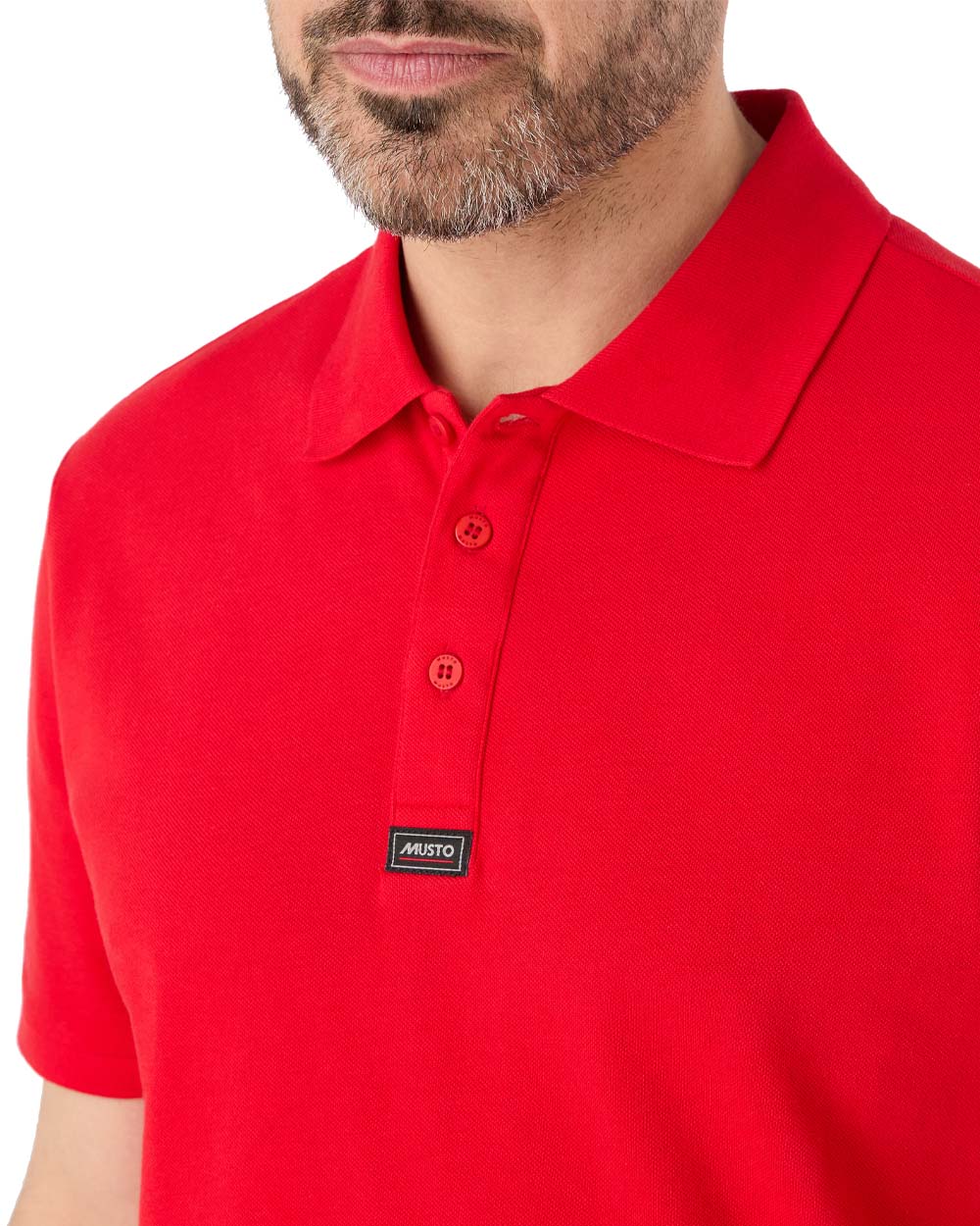 True Red coloured Musto Essential Pique Polo Shirt on White background