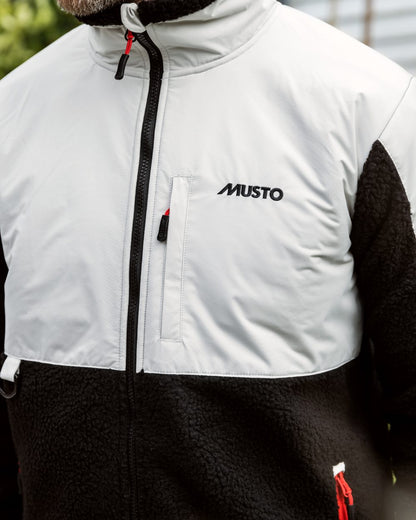 Black/Platinum Coloured Musto Mens 64 Sherpa Fleece Jacket On A Street Background