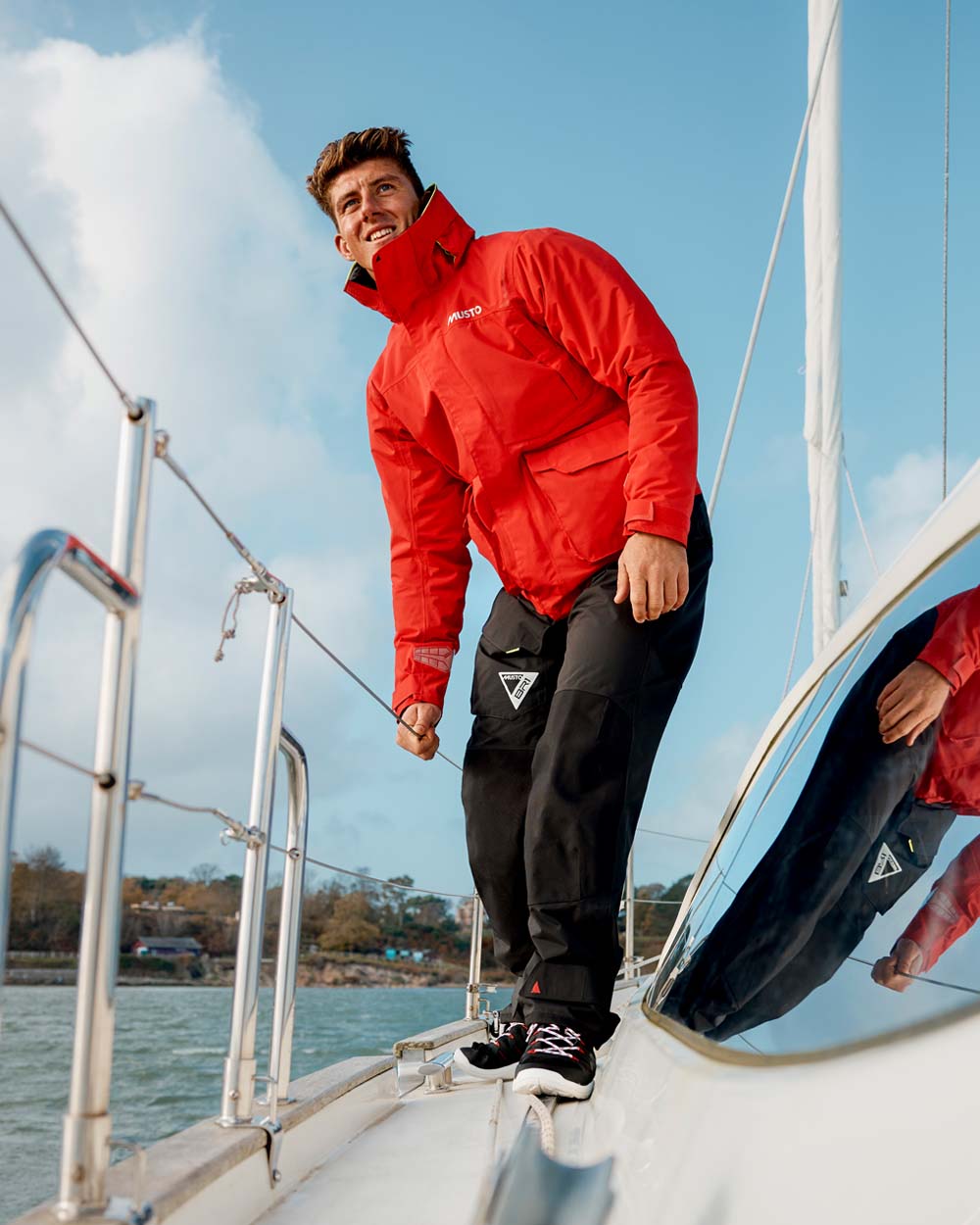 True Red coloured Musto Mens BR1 Channel Jacket on Sailing background
