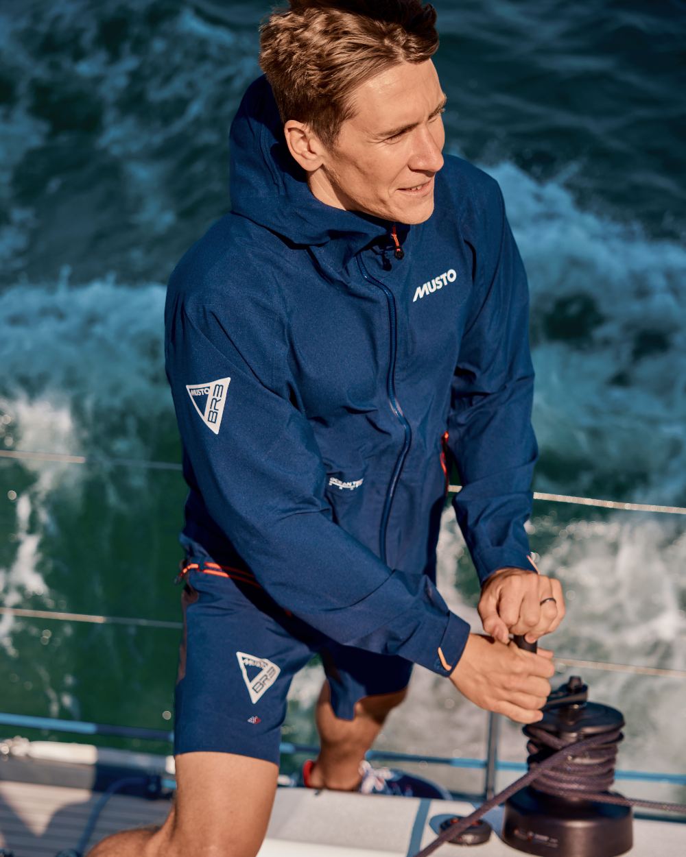 True Navy Coloured Musto Mens Br3 Sport Jacket on Sea Background