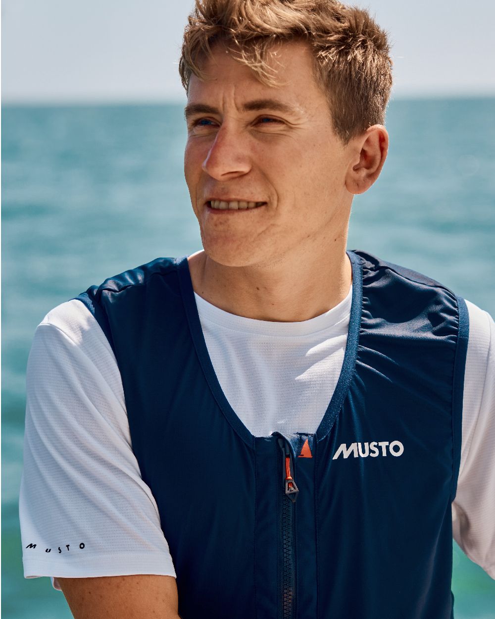 True Navy Coloured Musto Mens Br3 Sport Salopette on Blurry Background