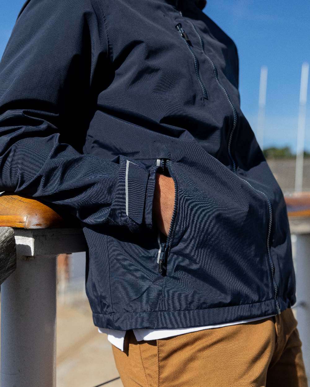 True Navy Coloured Musto Mens Sardinia Jacket on Beach Background