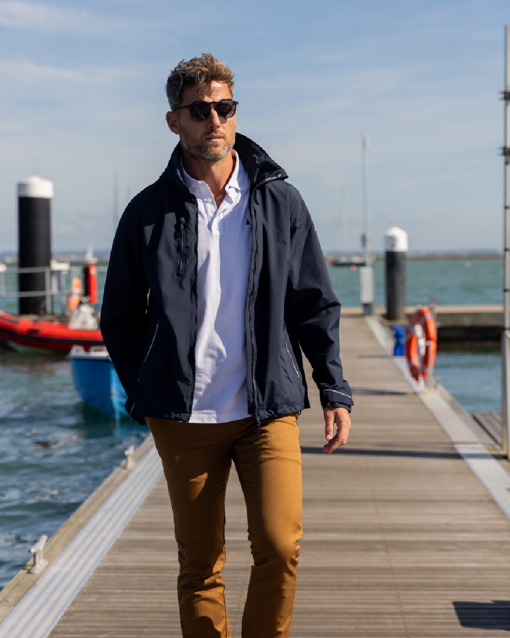 True Navy Coloured Musto Mens Sardinia Jacket on Beach Background