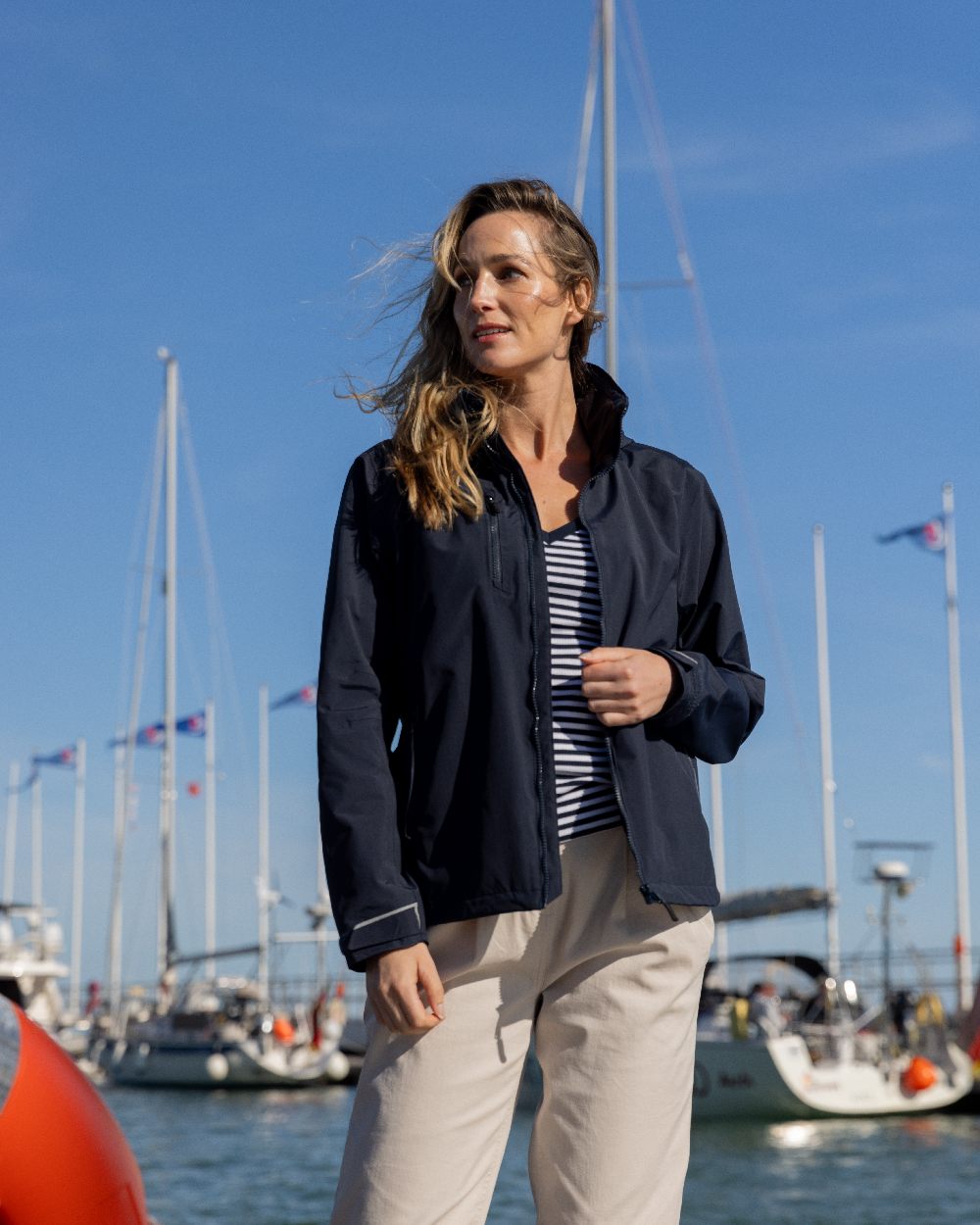 True Navy Coloured Musto Womens Corsica Jacket on Beach Background