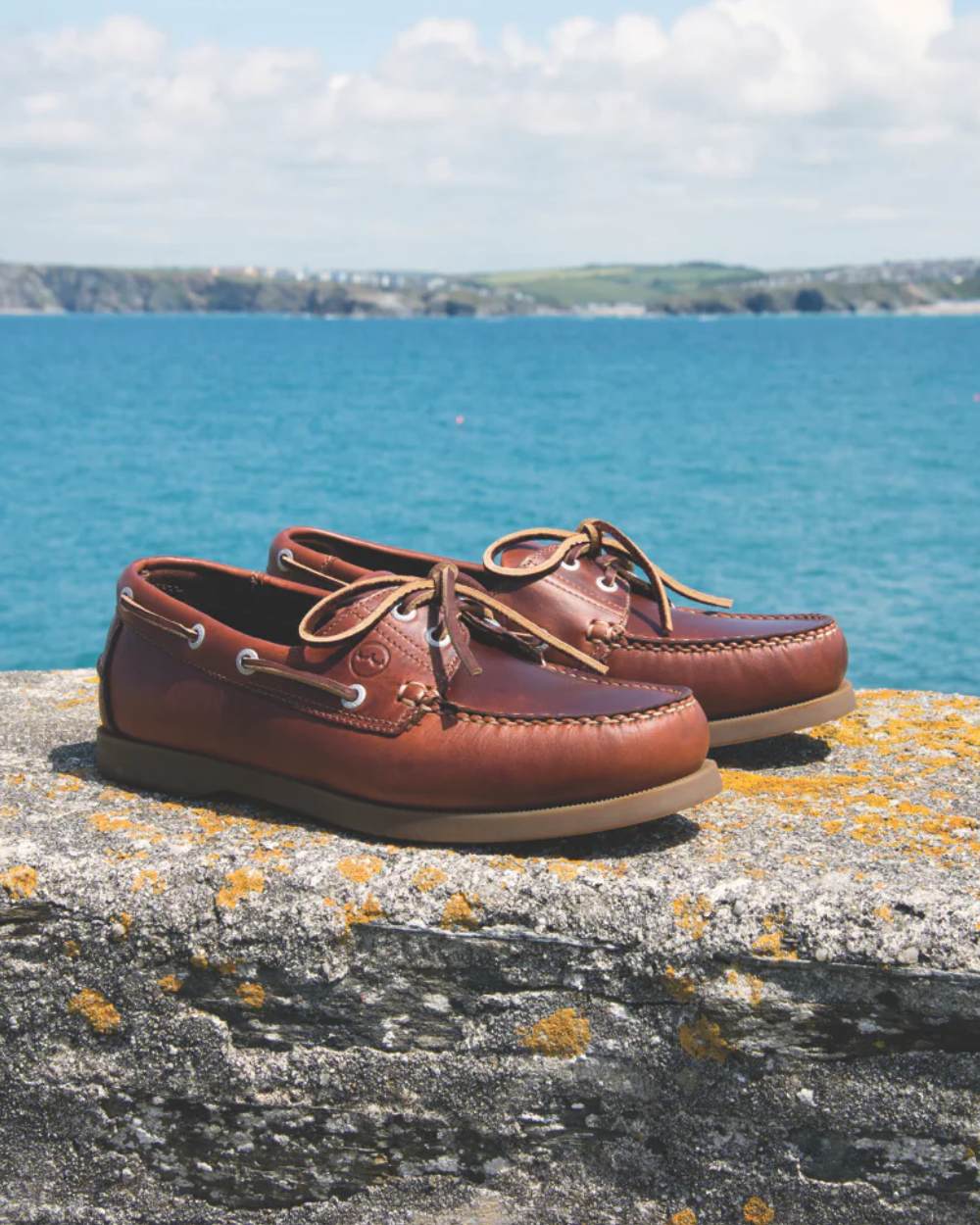Saddle Coloured Orca Bay Creek Mens Deck Shoes On A Coastal Background