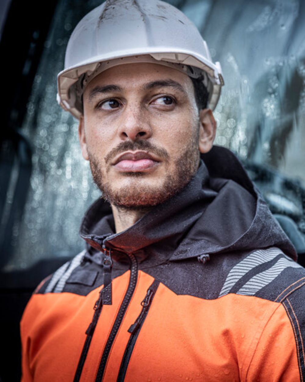 Black Orange Coloured Regatta Mens Hi-Vis X-Pro Waterproof Shell Jacket Class 2 on Blurry Background