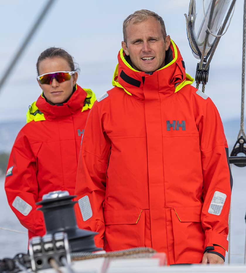 Sailing Jackets couple wearing red Helly Hansen Sailing jackets on a sailing yacht.