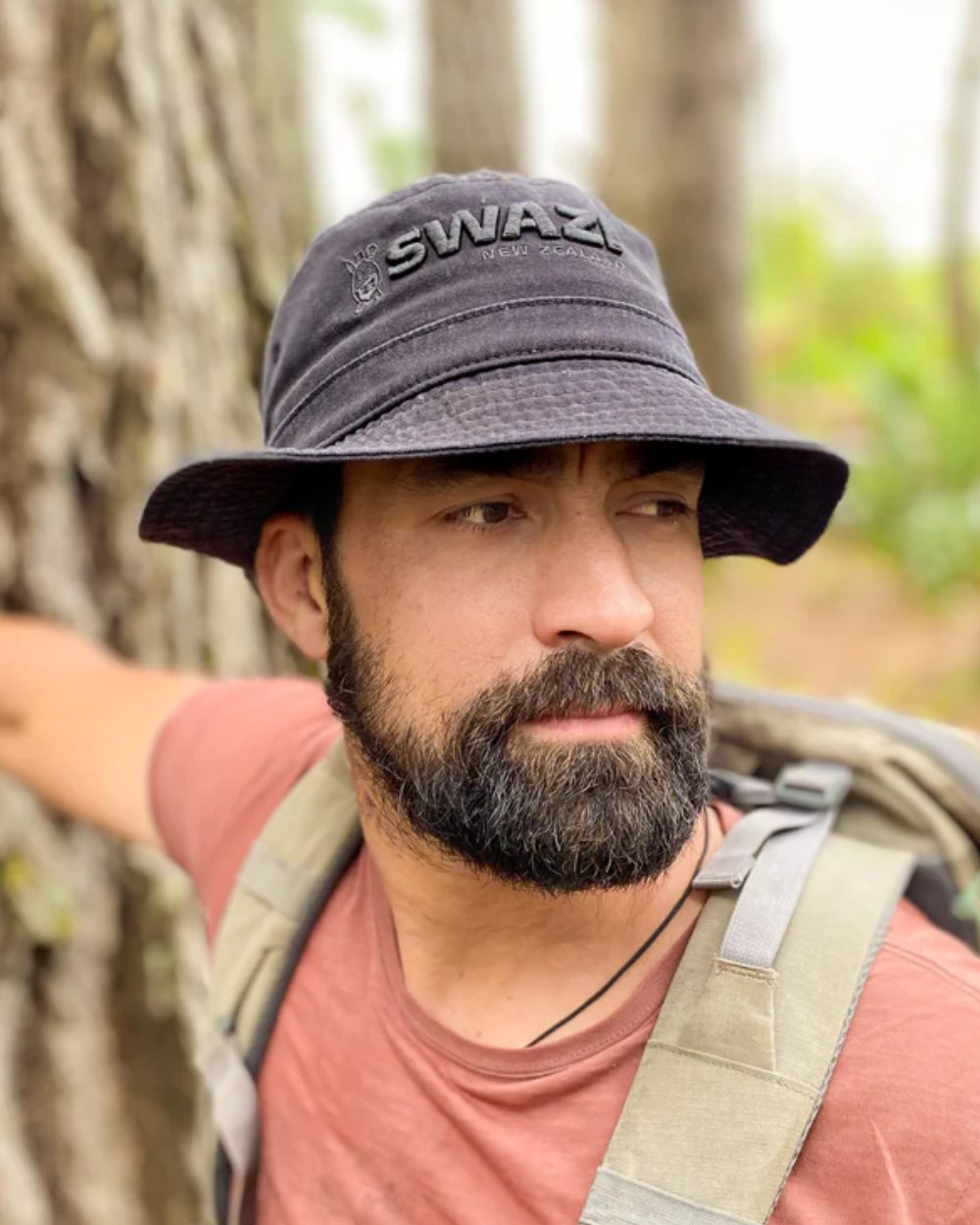 Black Coloured Swazi Bucket Hat On A Forest Background