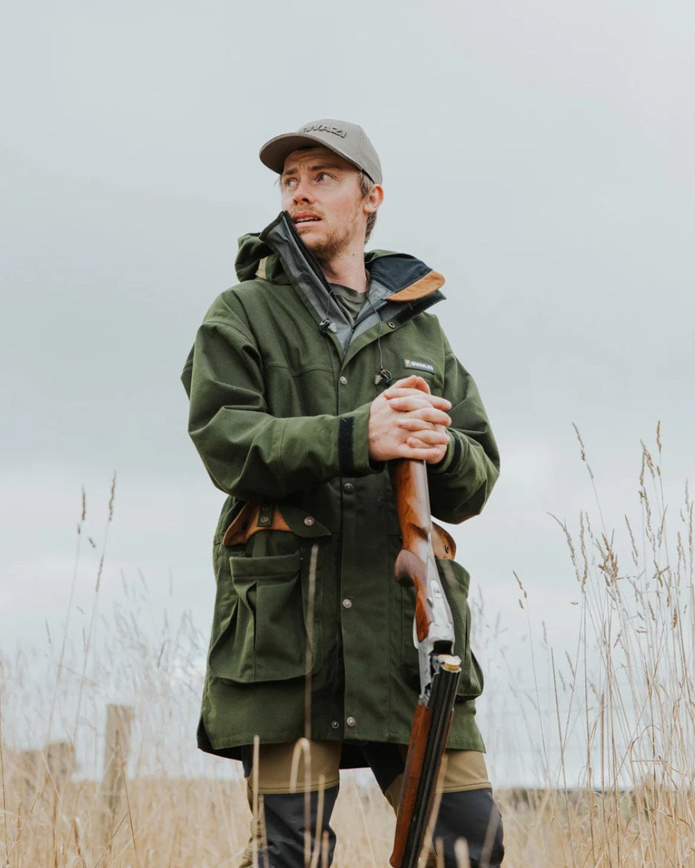Olive Coloured Swazi Wapiti Xp Jacket On A Forest Background
