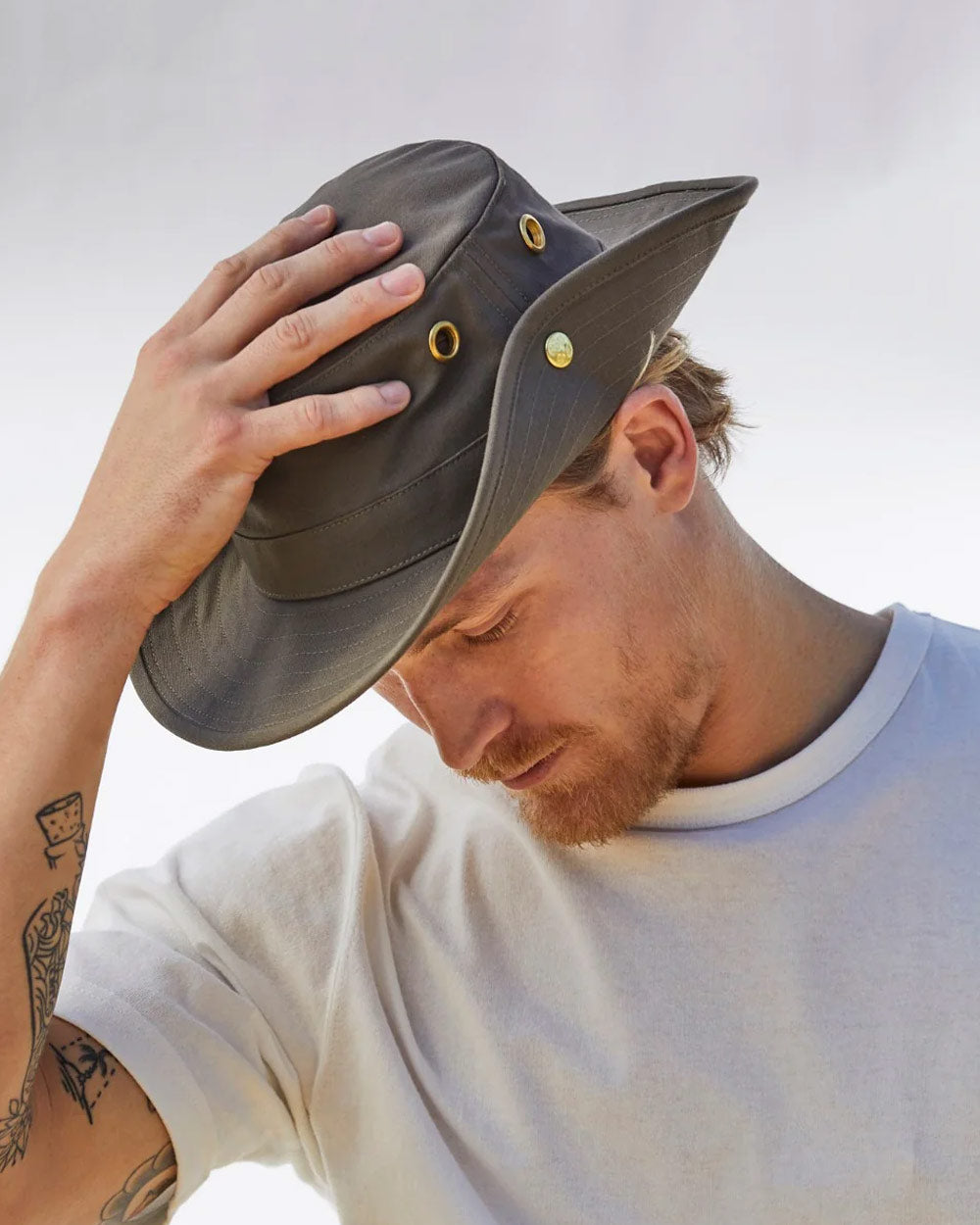 Khaki coloured Tilley Classic T3 Cotton Hat on Blurred Sky background