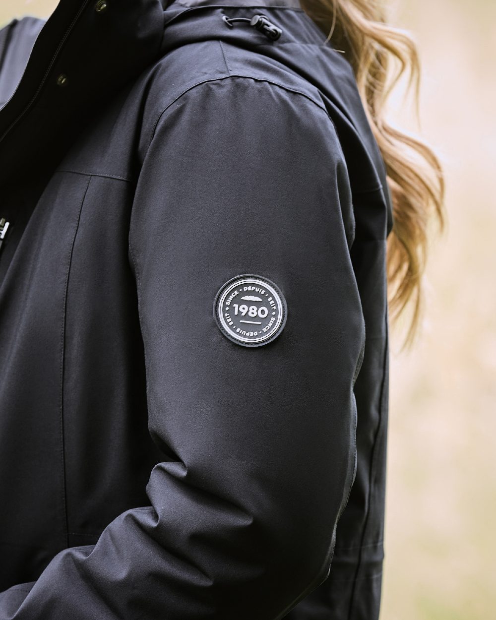 Black Coloured WeatherBeeta Kyla II Waterproof Jacket On A Stable Background