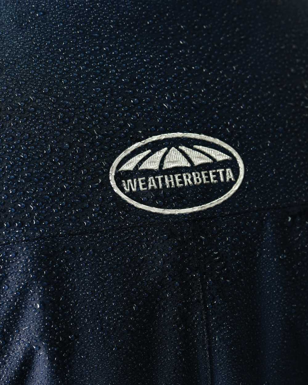 Navy Iris Coloured WeatherBeeta Kyla II Waterproof Jacket On A White Background