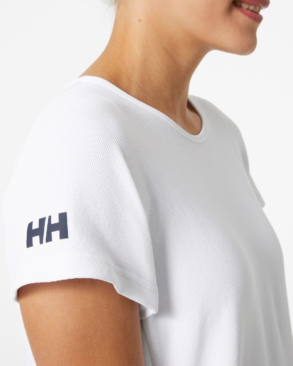 White coloured Helly Hansen womens crewline quick dry top on grey background 